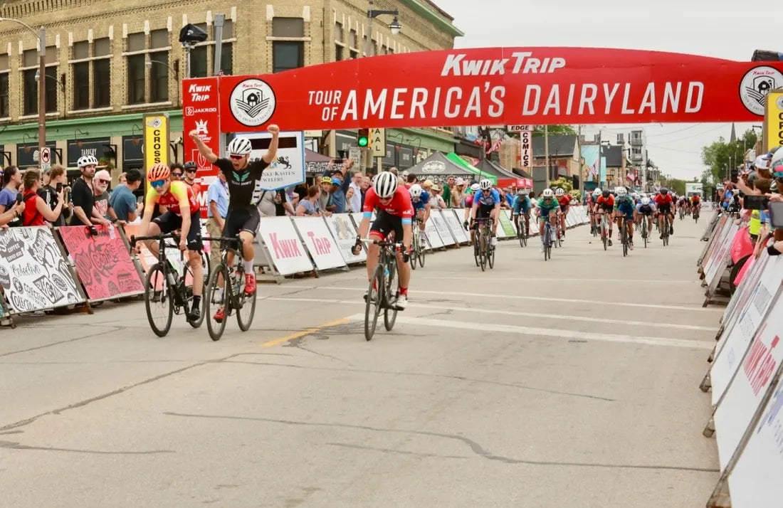 Cyclist throwing arms up at the finish line of a criterium race